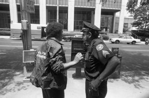 Hostage negotiator and police officer outside of Atlanta's F.B.I. headquarters during a hostage situation, Atlanta, Georgia, June 29, 1981.