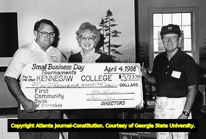 President of Kennesaw State University (then Kennesaw College) Betty Siegal accepting a $5,000 check following the first Annual Small Business Day golf and tennis tournaments, Kennesaw, Georgia, April 7, 1988.