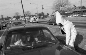 Ku Klux Klan member distributing literature to passing cars, Jonesboro, Georgia, January 30, 1982.