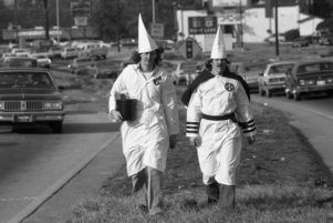 Ku Klux Klan member distributing literature to passing cars, Jonesboro, Georgia, January 30, 1982.