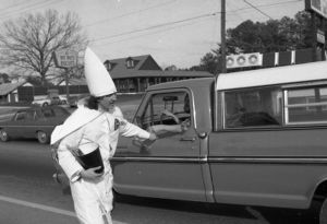 Ku Klux Klan member distributing literature to passing cars, Jonesboro, Georgia, January 30, 1982.