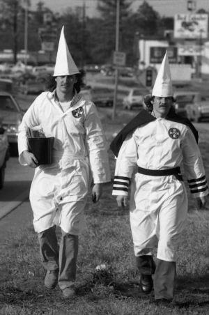 Ku Klux Klan member distributing literature to passing cars, Jonesboro, Georgia, January 30, 1982.