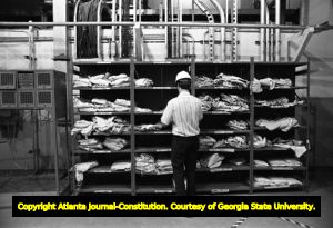 Worker inspecting uniforms at the Edwin I. Hatch Nuclear plant, Baxley, Georgia, August 20, 1977.
