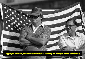 Men next to an American flag during Union Auto Workers protest against imported goods, Hapeville, Georgia, August 30, 1980.