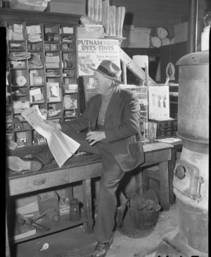 Reading the newspaper and enjoying a coke at the general store, Young Harris, Georgia, January 1947.