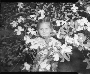 Little girl standing inside a dogwood tree, Atlanta, Georgia, April 1947.