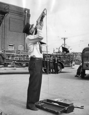 Fire Department rescue team member trying out a grapple gun, Atlanta, Georgia, December 8, 1940.