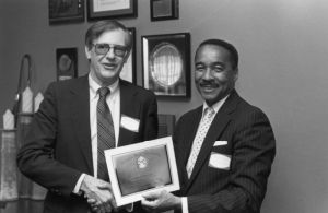 Dr. Alonzo Crim accepts a certificate of excellence for the Atlanta Teacher of the Year from Dr. Jerry Robbins, dean of the GSU College of Education, Atlanta, Georgia, circa 1980s.