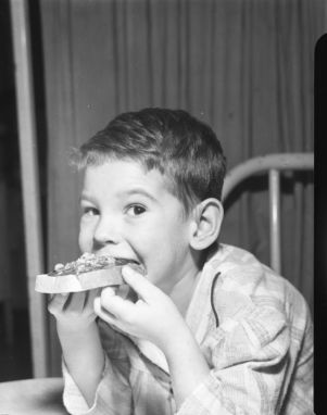 Young boy enjoying honeycomb on bread, Atlanta, Georgia, February 17, 1946.