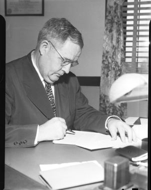 Methodist Bishop Arthur James Moore working at his desk, Atlanta, Georgia, May 1946.
