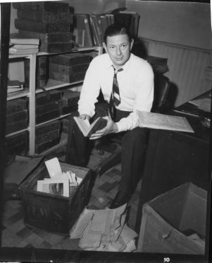 Bowling C. Yates, superintendent of the Kennesaw Battlefield National Park, sorting through material taken from Barnsley Gardens, near Adairsville, Bartow County, Georgia, circa March 1947.
