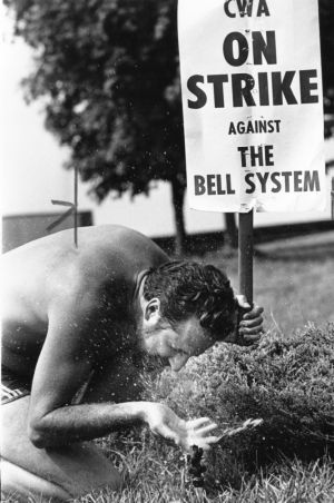 CWA member cooling off in a sprinkler outside the Bell building while picketing, Atlanta, Georgia, August 21, 1983.