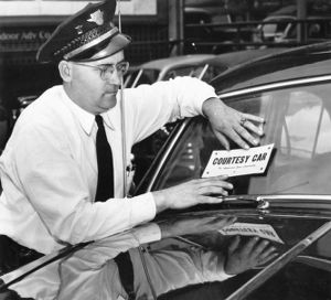 Striking trolley car operator puts a "Courtesy Car" placard on his car, Atlanta, Georgia, May 1950.