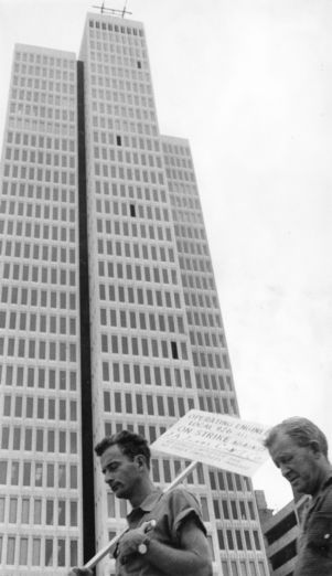 Hoist operators picketing outside the uncompleted Peachtree Center building during a strike, Atlanta, Georgia, July 1965.