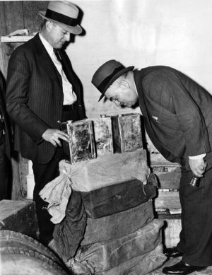Police inspecting seized moonshine, Georgia, circa late 1930s or early 1940s.