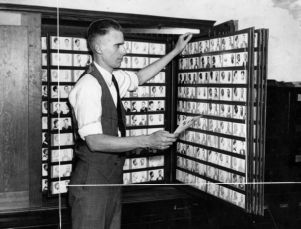 Police captain checking fingerprints in the morgue, Atlanta, Georgia, October 1940.
