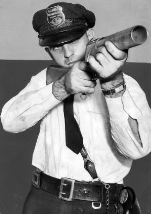 Brinks armored car guard with a grenade launcher, September 1943.