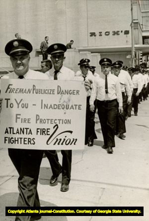Atlanta firemen in uniform, on Peachtree Street outside Rich's Department Store, picketing, Atlanta, Georgia, May 1966.