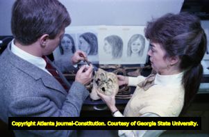 GBI special agent and forensic anthropologist examine the remains of an unidentified woman, 1988
