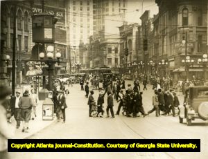 Bustling street scene of pedestrians and street cars in downtown Five Points, circa 1920s