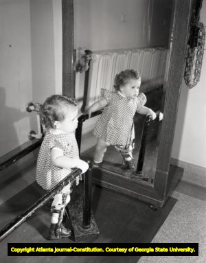 Polio stricken child walking with leg supports, circa 1940s