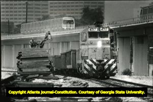 Railroad crew unloading supplies for track repairs, 1985