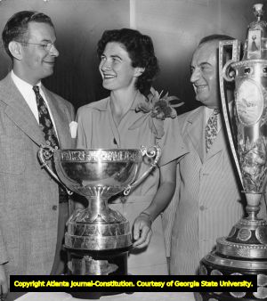 Louise Suggs with two of her trophies from the British Ladies' title and U. S. Amateur championship, 1948