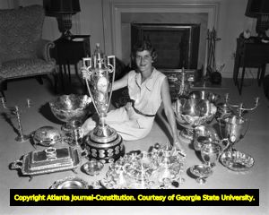 Mary Lena Faulk sits with her golf championship trophies and awards, 1953