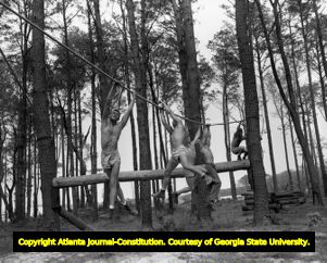 Navy frogmen training on a rope course, 1956