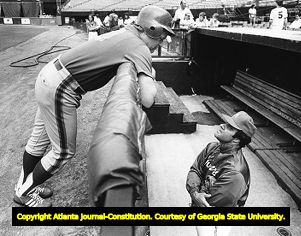 Atlanta Braves manager Joe Torre chats with Mets Rusty Staub over the dugout rail, 1982