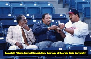 Braves fan Mark McEwen gets a baseball signed by Hank Aaron and Willie Stargell, 1991