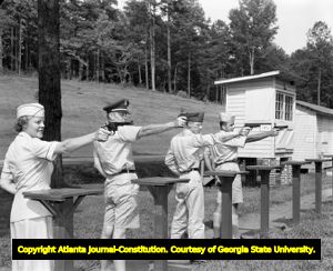 Major Katherine Sutherland competes as a sharpshooter for the Fort McPherson pistol team, 1958