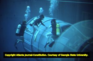 Carolyn Griner, Amy Whitaker, and Mary Johnson during an underwater training exercise simulating weightlessness in space, 1976