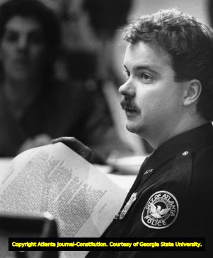 Police Officer Lance Alford holds his typed interview with Alice Bond, 1987