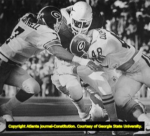 Georgia Bulldogs gang-tackle a Texas Longhorn Ronnie Robinson during the Cotton Bowl, 1984
