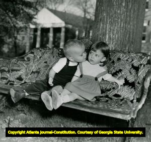 Children Dan Smith and Carol Britt Greear sitting on a cast-iron bench at the University of Georgia, Athens, Georgia, 1940s?