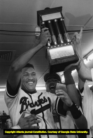 Francisco Cabrera of the Atlanta Braves holds up the National League championship trophy, 1992
