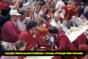 Ronnie Arrow, South Alabama basketball coach, celebrating victory over Alabama with his family, 1989