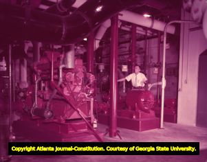 Chief Engineer J. B. Hamil checks the fire and emergency equipment in the basement of Grady Hospital, 1958