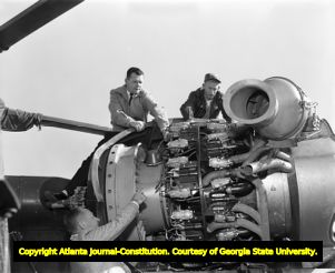 Helicopter mechanics take a look at the inner workings of the engine, 1958
