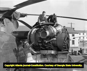 Fort Gillem helicopter mechanics work on repairing an engine, 1958