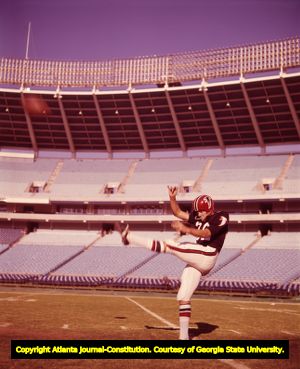 Billy Lothridge practices punting in an empty stadium, 1967