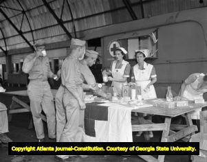 American Red Cross nurses supply returning airmen with beverages at Hunter Air Field, 1945