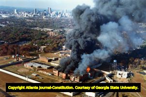 Atlanta Federal Penitentiary belching smoke after rioters set part of the building on fire, 1987