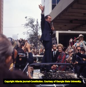Richard Nixon greets supporters during a presidential campaign parade, 1968