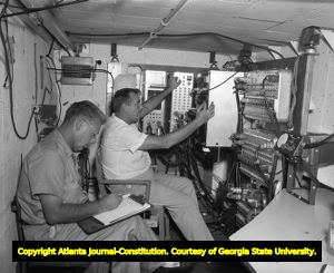 Ocean oil prospectors record readings from below deck, 1960
