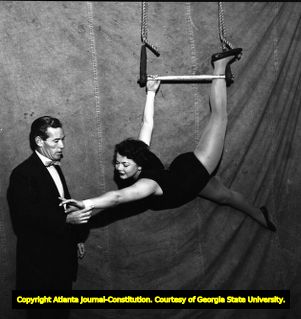 Woman circus performer "Bubbles" showing her aerial form, 1955