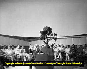 Class sits inside the Athen's planetarium for a lecture, 1959