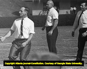 Georgia Bulldog coaches Vince Dooley, Erskine Russell, and Bill Dooley during a game, 1984
