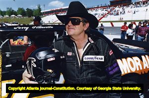Falcons' coach Jerry Glanville attempts race car driving during the Busch Grand National circuit, 1992